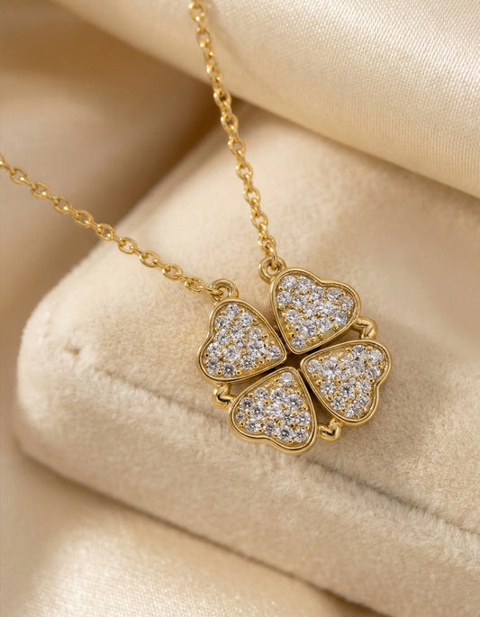 Gold necklace with a heart-shaped pendant on a beige background