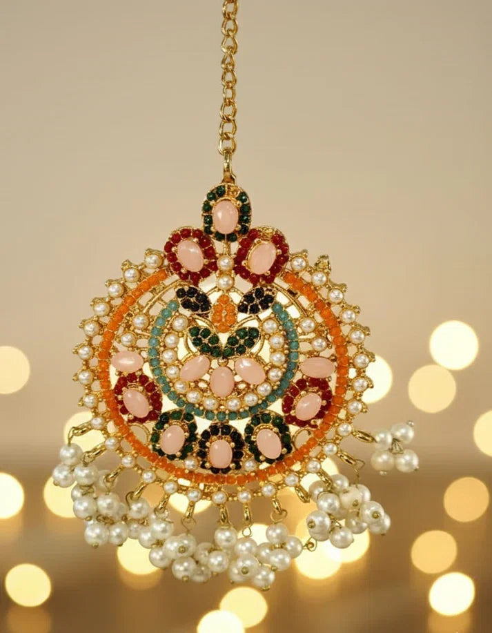 Decorative hanging ornament with pearls and gemstones on a blurred background