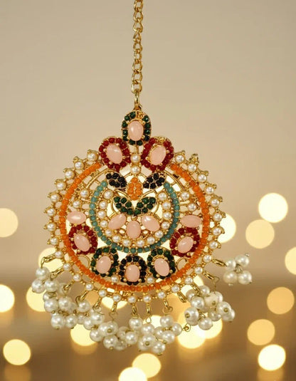 Decorative hanging ornament with pearls and gemstones on a blurred background