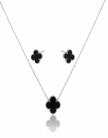 Clover-shaped necklace and earrings on a white background