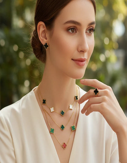 Woman wearing a necklace with green clover pendants against a blurred natural background