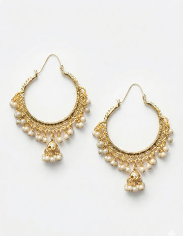 Gold hoop earrings with pearl accents on a white background
