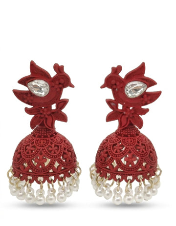 Red earrings with intricate designs and pearl-like beads on a white background