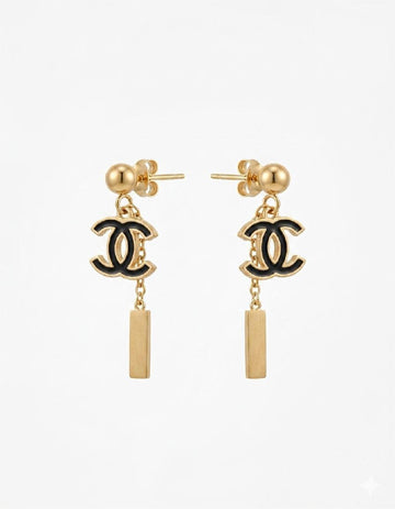 Gold earrings with black CC logos on a white background