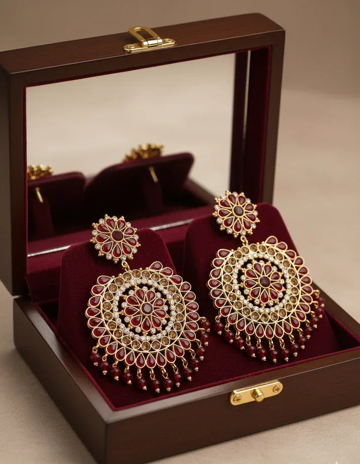 Rose Dew premium ruby red jhumka dangle earrings with gold-tone plating and simulated stone embellishments for Indian bridal wear