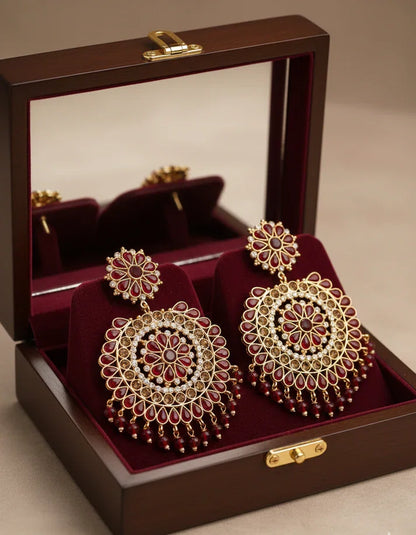 Rose Dew premium ruby red jhumka dangle earrings with gold-tone plating and simulated stone embellishments for Indian bridal wear