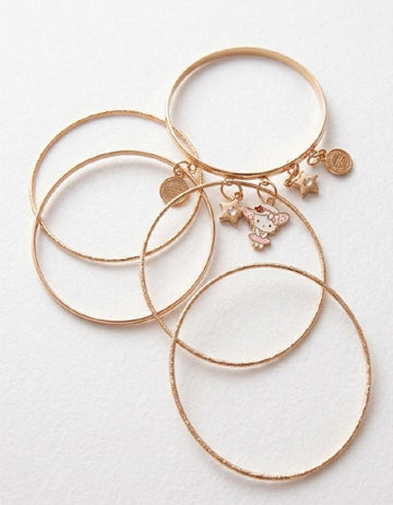 Set of gold bangles with charms on a white background