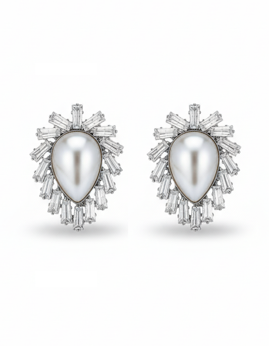 Pair of earrings with a central pearl surrounded by diamond-like stones on a white background