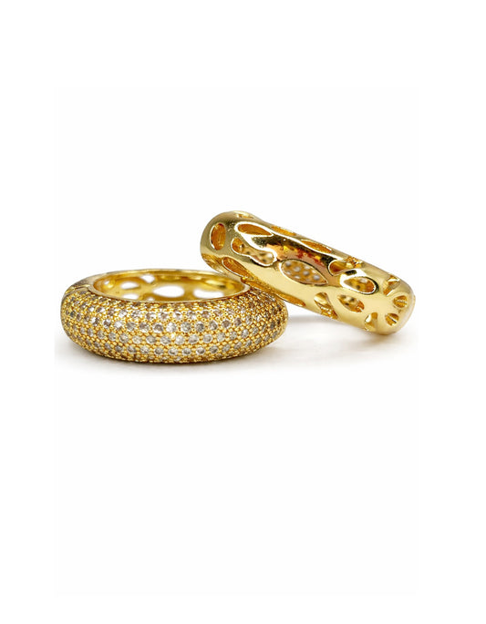Two gold rings with diamond accents on a white background