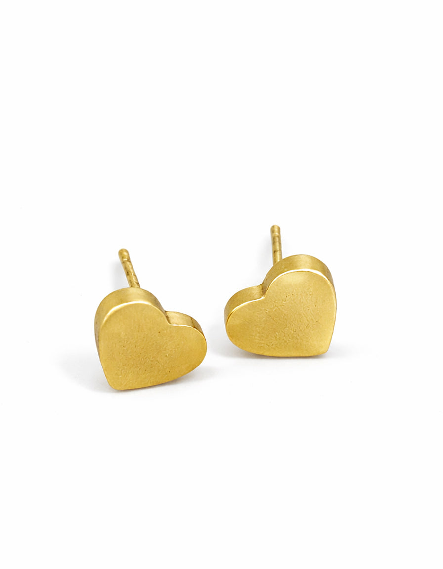 Gold heart-shaped earrings on a white background