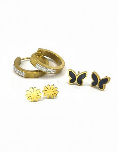 Set of gold hoop earrings, gold flower stud earrings, and black butterfly earrings on a white background
