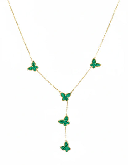 Gold necklace with green butterfly pendants on a white background