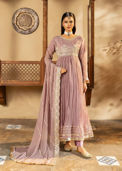 Woman in a mauve traditional outfit with intricate embroidery in a decorative setting