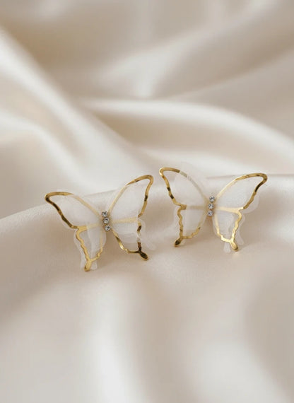 Close up white silk fabric butterfly wings gold frame crystal center Rose Dew