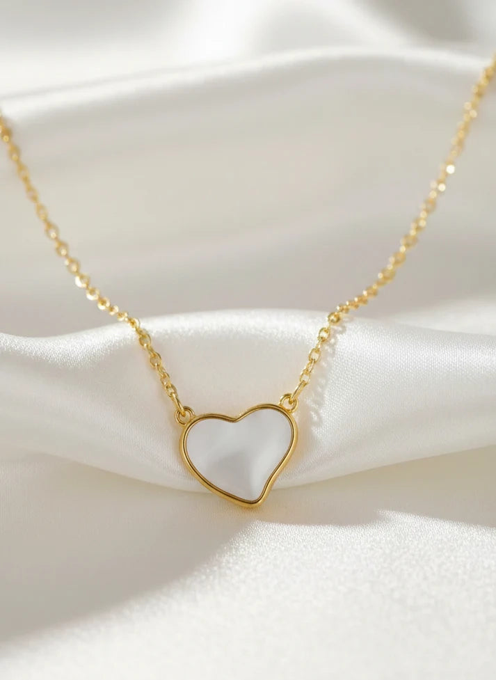 Close up white heart inlay gold frame pendant necklace Rose Dew romantic