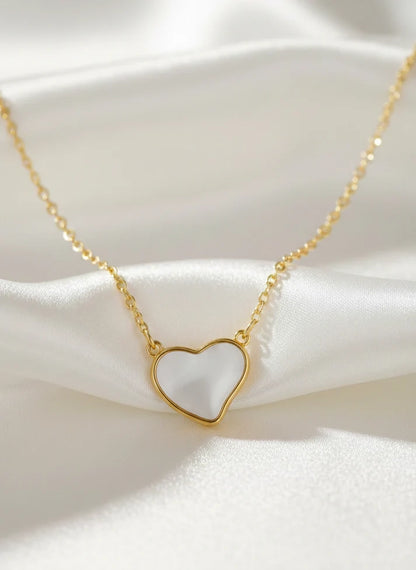 Close up white heart inlay gold frame pendant necklace Rose Dew romantic