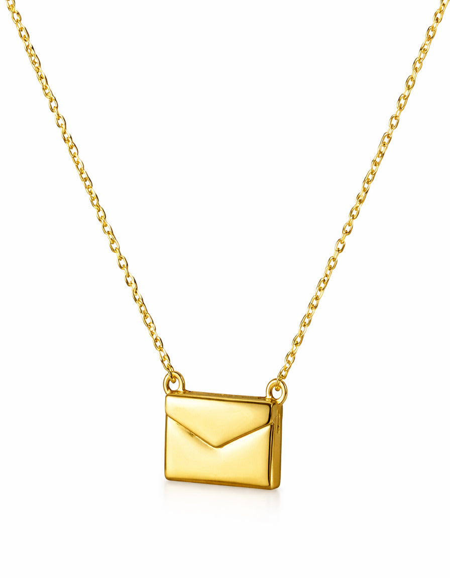 Gold envelope pendant necklace on a white background